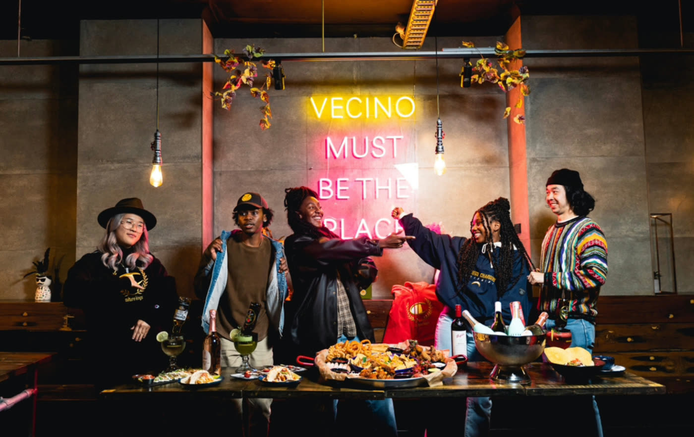Guests toasting under the VECINO Must Be The Place neon sign, Glebe Sydney
